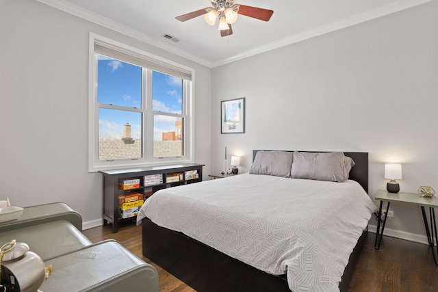 bedroom with baseboards, visible vents, a ceiling fan, ornamental molding, and wood finished floors