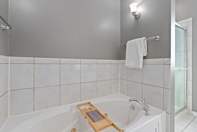 full bath featuring a whirlpool tub, a stall shower, and tile patterned floors