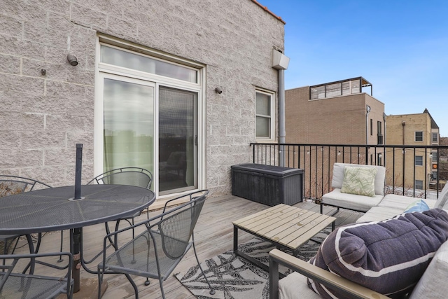 wooden terrace with outdoor dining area