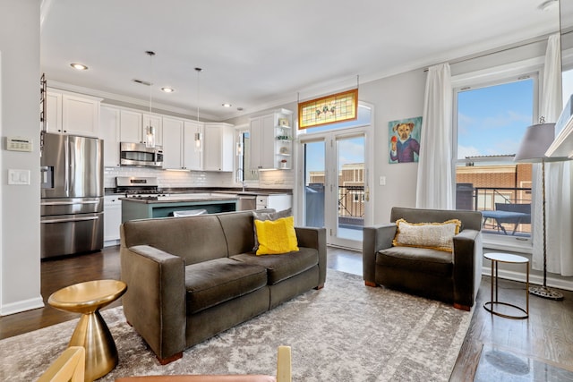 living area with ornamental molding, dark wood-style flooring, and a wealth of natural light