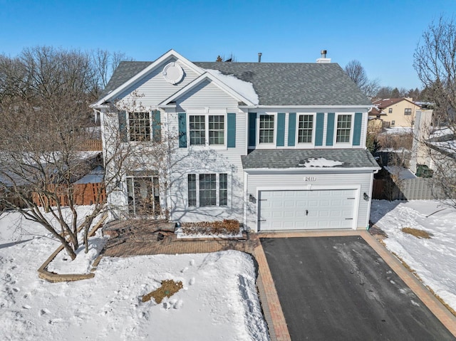 view of front of property featuring aphalt driveway, a shingled roof, and a garage