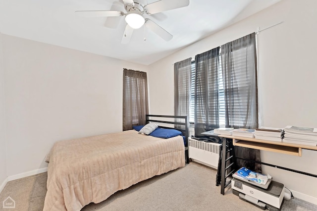 bedroom featuring radiator, ceiling fan, light carpet, and baseboards