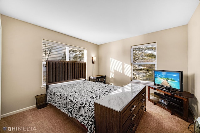 carpeted bedroom featuring multiple windows and baseboards