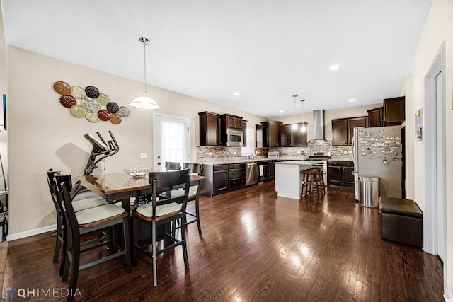 dining room with recessed lighting, dark wood-style flooring, and baseboards