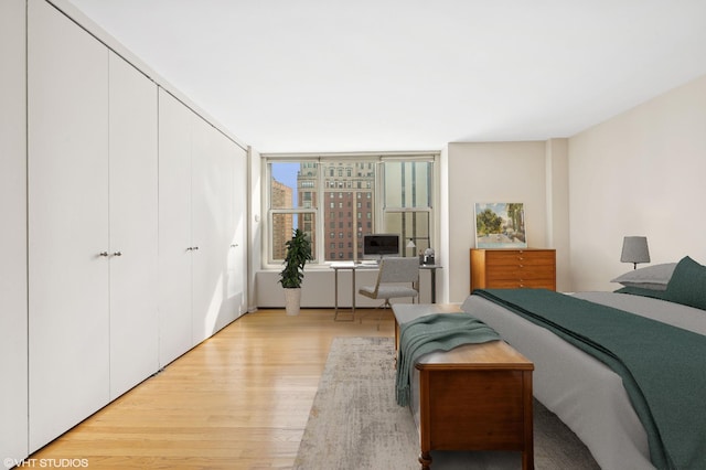 bedroom featuring a closet and light wood-style flooring