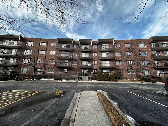 view of property featuring uncovered parking