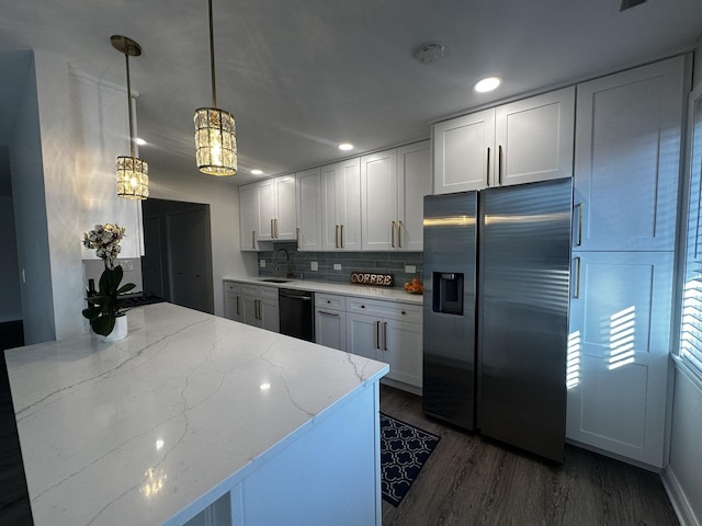 kitchen with light stone counters, dark wood-style floors, stainless steel fridge with ice dispenser, decorative backsplash, and dishwasher