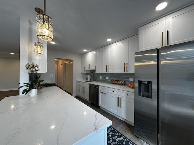 kitchen with light stone counters, stainless steel refrigerator with ice dispenser, tasteful backsplash, a sink, and dishwashing machine