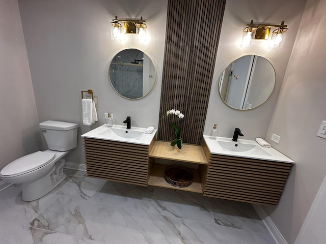 full bathroom featuring marble finish floor, a sink, toilet, and baseboards