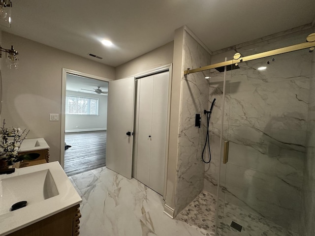 full bath featuring a marble finish shower, visible vents, a ceiling fan, marble finish floor, and vanity