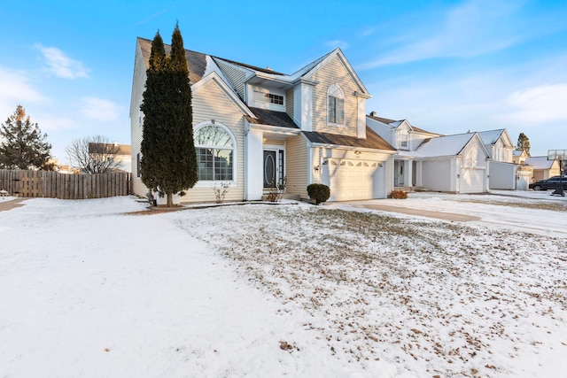 view of front of house with concrete driveway, an attached garage, fence, and a residential view