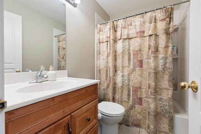 bathroom with tile patterned flooring, vanity, and toilet