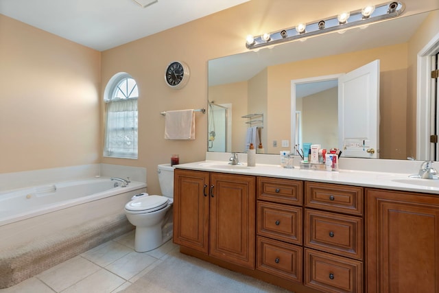 bathroom featuring toilet, tile patterned flooring, double vanity, and a sink