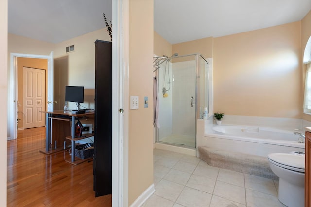 bathroom featuring vanity, visible vents, a shower stall, a bath, and tile patterned floors