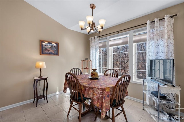 dining space with a chandelier, a wealth of natural light, baseboards, and light tile patterned floors