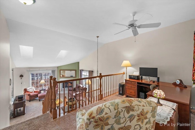 carpeted office with lofted ceiling with skylight and ceiling fan