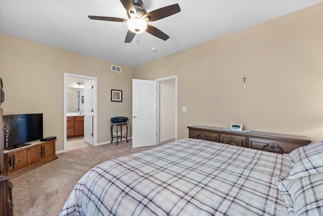 bedroom featuring connected bathroom, light carpet, a ceiling fan, visible vents, and baseboards