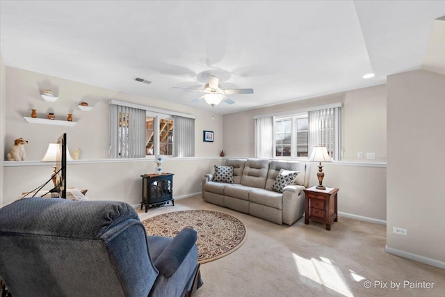 living area with baseboards, visible vents, ceiling fan, vaulted ceiling, and carpet floors