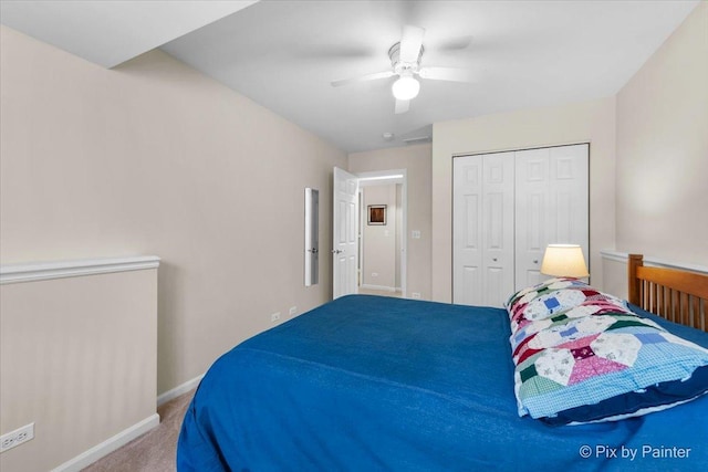 bedroom with carpet floors, ceiling fan, baseboards, and a closet