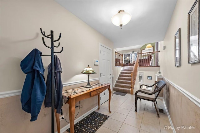 interior space featuring visible vents, wainscoting, stairway, and light tile patterned floors