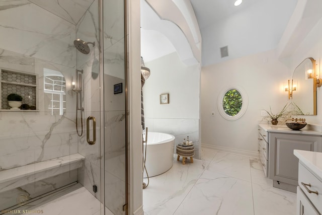 full bath with vanity, marble finish floor, a marble finish shower, and a freestanding bath