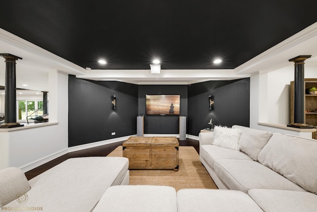 cinema with recessed lighting, baseboards, a raised ceiling, and ornate columns