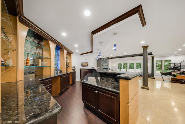 kitchen featuring open shelves, recessed lighting, open floor plan, and ornate columns