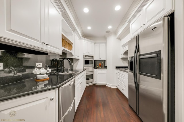 kitchen with dark wood finished floors, recessed lighting, a sink, stainless steel appliances, and white cabinets