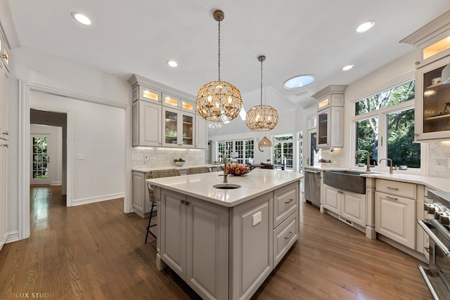 kitchen featuring a center island, plenty of natural light, stainless steel appliances, and dark wood-style flooring