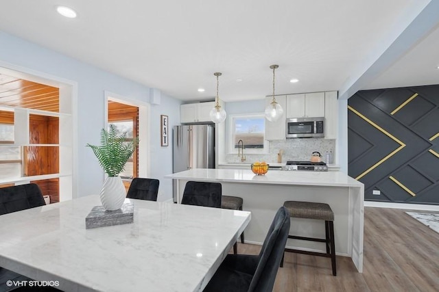 dining area featuring recessed lighting and wood finished floors