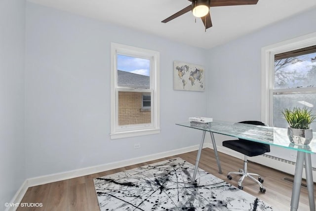 office with ceiling fan, baseboards, and wood finished floors