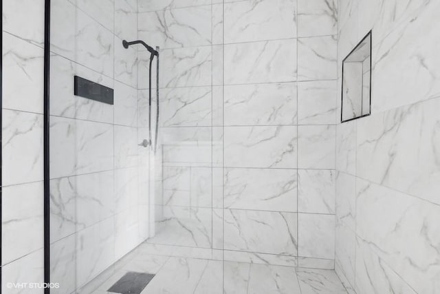 full bathroom with tiled shower