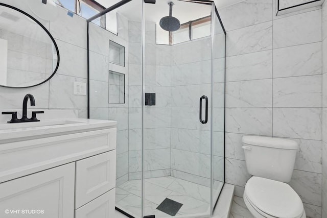 full bath featuring a stall shower, toilet, tile walls, and vanity