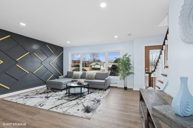 living room featuring baseboards, stairway, wood finished floors, and recessed lighting