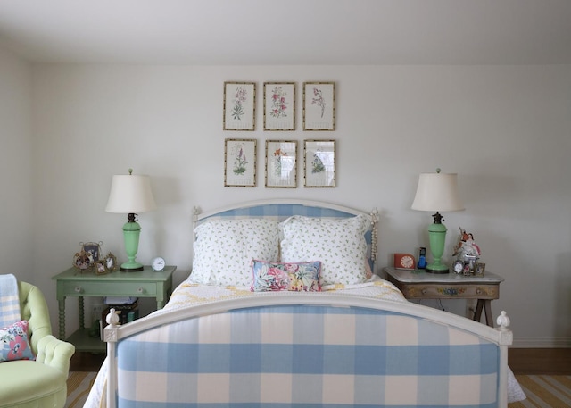 bedroom with wood finished floors and baseboards