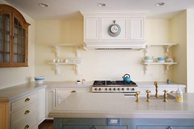 kitchen featuring open shelves, recessed lighting, range, and light countertops