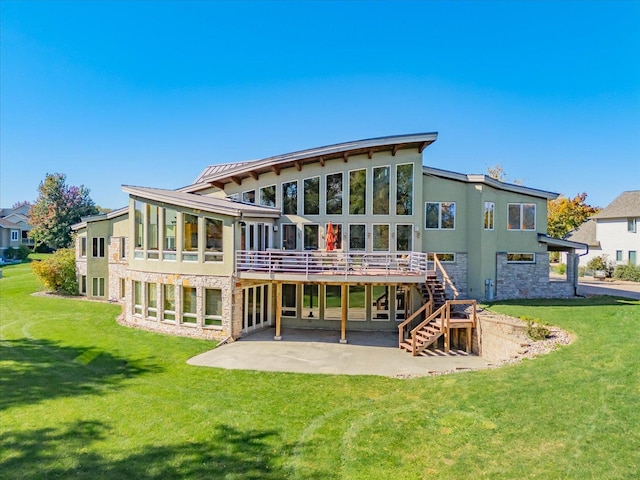 back of property featuring stone siding, a yard, stairway, and a patio