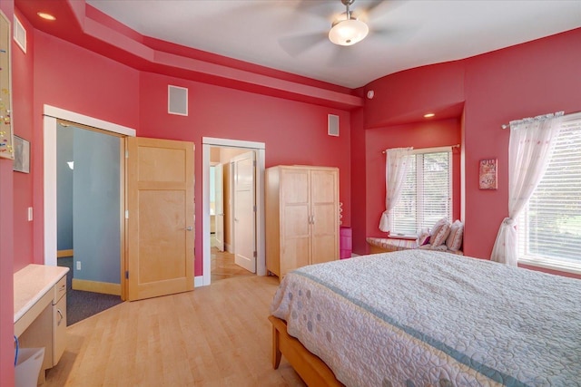 bedroom with light wood-style floors, baseboards, and visible vents