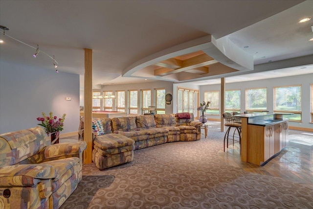 living area with coffered ceiling and baseboards