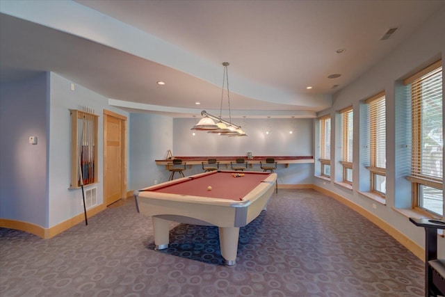 recreation room with a healthy amount of sunlight, visible vents, and baseboards