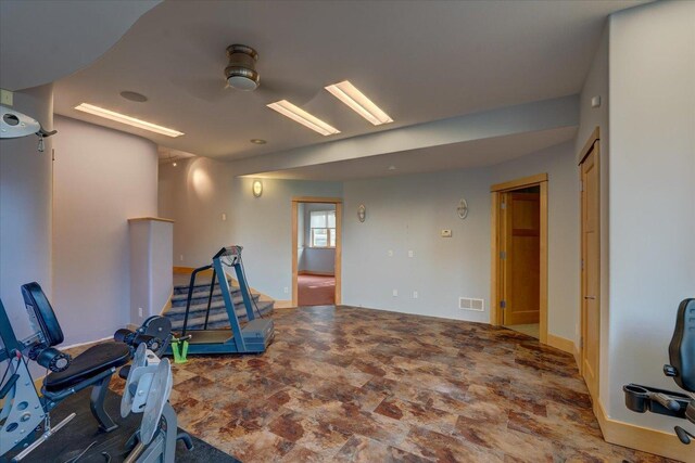 exercise area with stone finish floor and visible vents