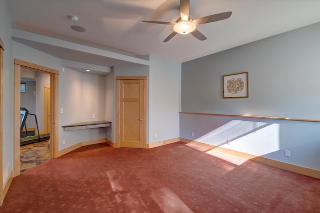 empty room featuring carpet, ceiling fan, and baseboards