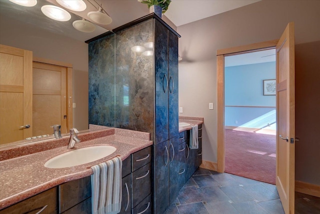 full bath featuring vanity and baseboards