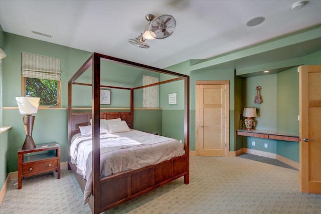 bedroom with baseboards and light colored carpet