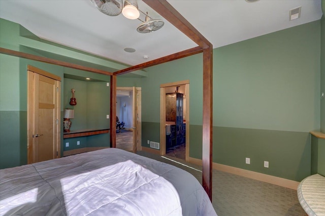 carpeted bedroom with visible vents and baseboards