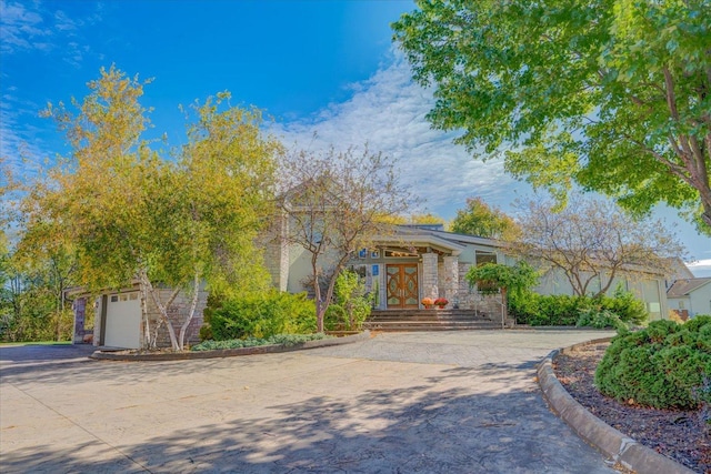 view of front of home with a garage, decorative driveway, and french doors