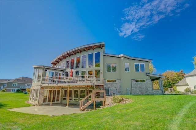 back of house with central air condition unit, a yard, stone siding, a wooden deck, and a patio area