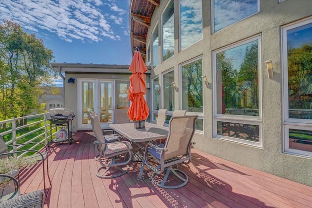 deck featuring a grill and outdoor dining space