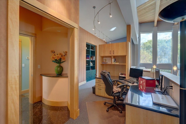 home office featuring rail lighting, baseboards, beam ceiling, and built in study area