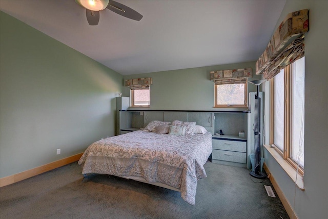 bedroom with a ceiling fan, baseboards, and carpet flooring